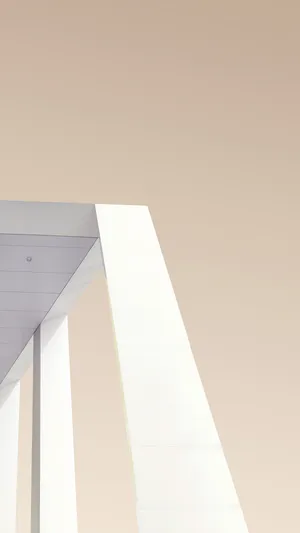 A Man Is Riding A Skateboard On A White Building Wallpaper