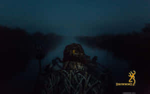 A Man Is Sitting In A Boat At Night Wallpaper