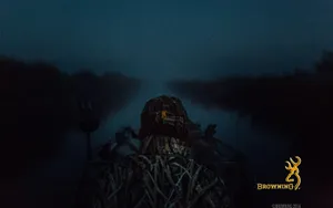 A Man Is Sitting In A Boat At Night Wallpaper