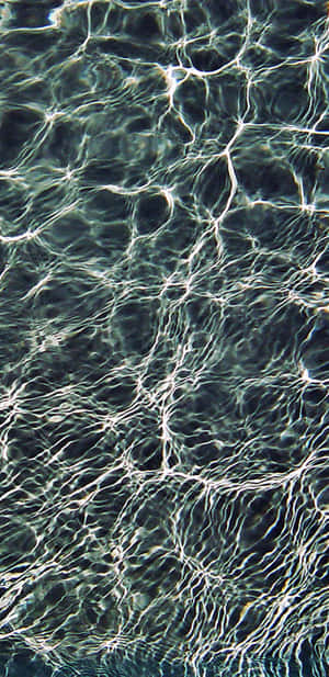 A Man Is Swimming In A Pool Wallpaper