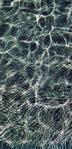 A Man Is Swimming In A Pool Wallpaper