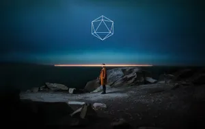 A Man Standing On Rocks At Night With A Geometric Shape In The Sky Wallpaper