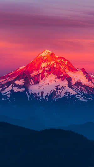 A Mountain Is Seen At Sunset With A Colorful Sky Wallpaper