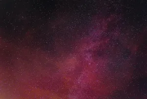 A Neon Pink Galaxy Filled With Stars Wallpaper