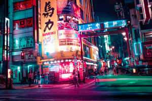 A Nightscape Of Tokyo Illuminated With Japanese Neon Signs Wallpaper