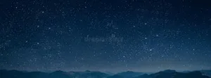 A Nighttime View Of The Majestic Mountains Wallpaper