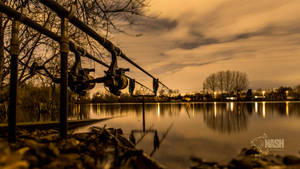 A Peaceful Day Of Carp Fishing By The Lake Wallpaper