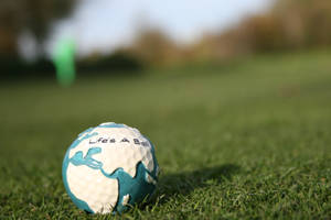 A Perfect Golf Ball On The Perfectly Cut Grass Wallpaper