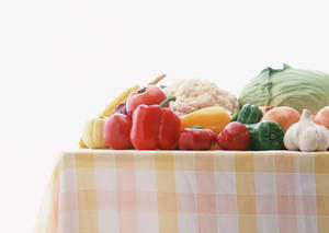 A Picnic Table Overflowing With Fresh Vegetables Wallpaper