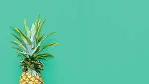 A Pineapple On A Turquoise Background Wallpaper