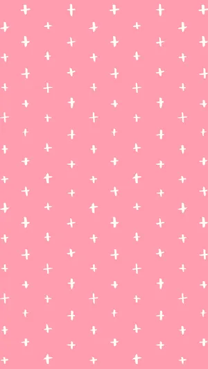 A Pink Background With White Crosses On It Wallpaper