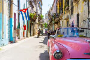 A Pink Car Parked On A Narrow Street Wallpaper