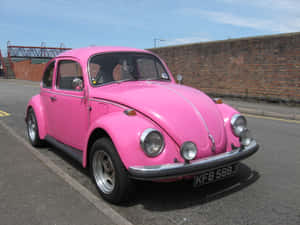 A Pink Car Parked On The Street Wallpaper