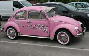 A Pink Volkswagen Beetle Parked In A Parking Lot Wallpaper