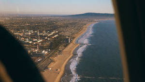 A Plane Window Shot Of A Wide Shoreline Wallpaper