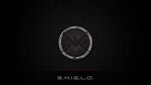 A Powerful Shield On A Regal Red Background Wallpaper