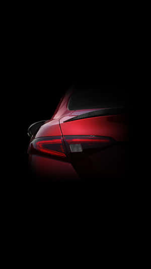 A Powerful, Sleek Red Car Against A Bright Blue Sky. Wallpaper