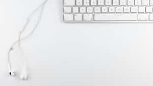 A Pristine White Laptop Provides The Perfect Aesthetic To Spark Creative Inspiration. Wallpaper