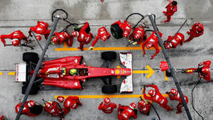 A Pulse-racing Moment At A F1 Pit Stop Wallpaper