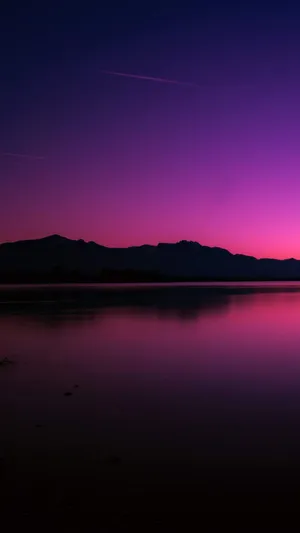 A Purple Sky With Mountains Wallpaper