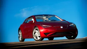 A Red Seat Ibe Parked In Paris Wallpaper