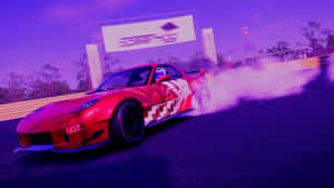 A Red Sports Car Driving Down A Track With Smoke Coming Out Of It Wallpaper