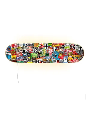 A Skateboard With Many Different Stickers On It Wallpaper