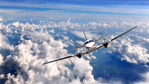 A Small Airplane Flying Through The Clouds Wallpaper