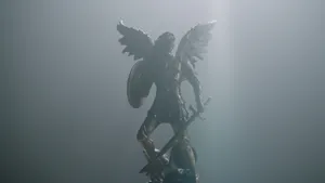 A Statue Of An Angel With A Shield In The Light Wallpaper