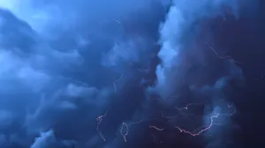 A Striking Streak Of Lightning In A Blue Cloud Wallpaper