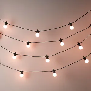A String Of Lights With A Pink Bulb Wallpaper