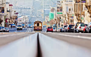 A Student In San Francisco Works Diligently On Her Laptop In The Heart Of The City. Wallpaper