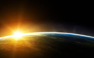 A Stunning View Of Planet Earth During Sunrise Wallpaper