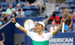 A Tennis Player Celebrating His Win On A Court Wallpaper