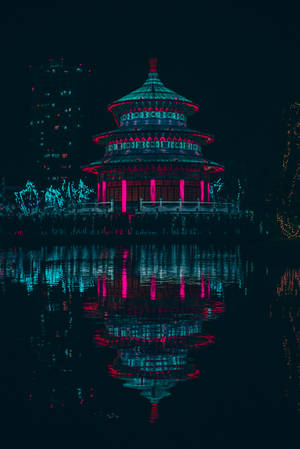 A Tranquil Pagoda Illuminated By The Stars. Wallpaper