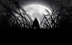 A Vampire Silhouette Under A Full Moon Wallpaper