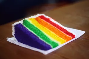 A Vibrant Gay Pride Celebration Symbolized By A Rainbow-layered Cake Wallpaper