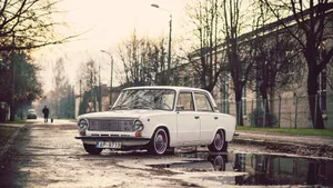 A Vintage Car In The Street Of Riga Wallpaper
