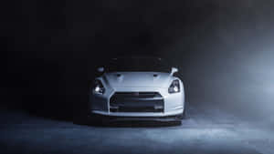 A White Car Is Sitting In A Dark Room Wallpaper