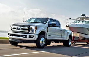 A White Ford Super Duty Truck Is Towing A Boat Wallpaper