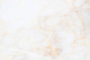 A White Marble Background With Gold And Yellow Wallpaper