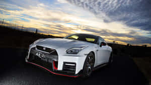 A White Nissan Gtr Parked On A Road Wallpaper