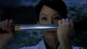 A Woman Holding A Sword In Her Hand Wallpaper