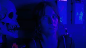 A Woman Is Standing In Front Of A Blue Wall Wallpaper