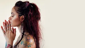 A Woman With Tattoos On Her Hands Praying Wallpaper