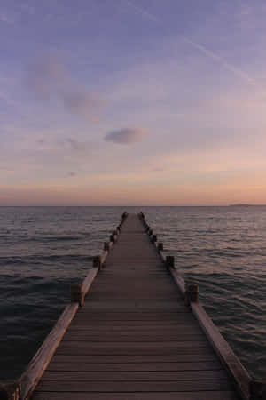 A Wooden Pier In The Water Wallpaper