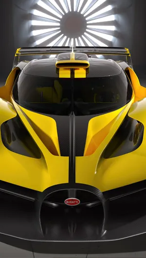 A Yellow And Black Car With A Light Shining On It Wallpaper