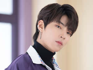 A Young Man In A Purple Shirt And Black Pants Wallpaper