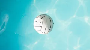 A Young Woman Experiencing The Fun And Joy Of Play Volleyball Wallpaper