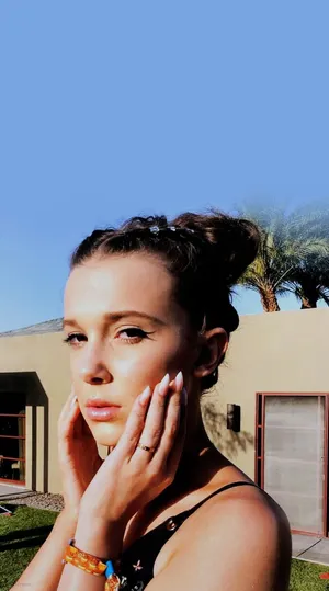 Actress Millie Bobby Brown Enjoying The Summer Season In Style Wallpaper